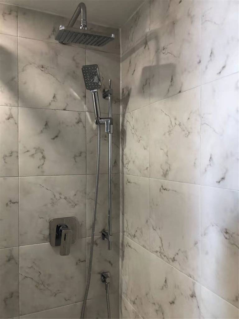 This Richmond Hill bathroom renovation features a modern marble-look tile shower with a sleek rainfall showerhead, handheld system, and minimalist chrome fixtures. Designed for comfort and durability, the upgraded shower space combines elegant finishes with functional layout improvements. Completed by a professional Toronto renovation company, this project delivers a clean, contemporary bathroom built for long-term use and everyday luxury.