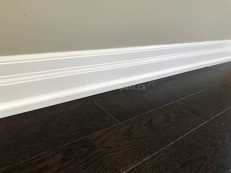 This Markham flooring renovation project features dark engineered hardwood flooring paired with crisp white baseboard trim for a clean and modern finish. The deep wood tone enhances contrast against neutral walls, creating a warm and elegant interior atmosphere. Professionally installed by a trusted Toronto renovation company, the flooring ensures durability, smooth alignment, and seamless transitions throughout the space.