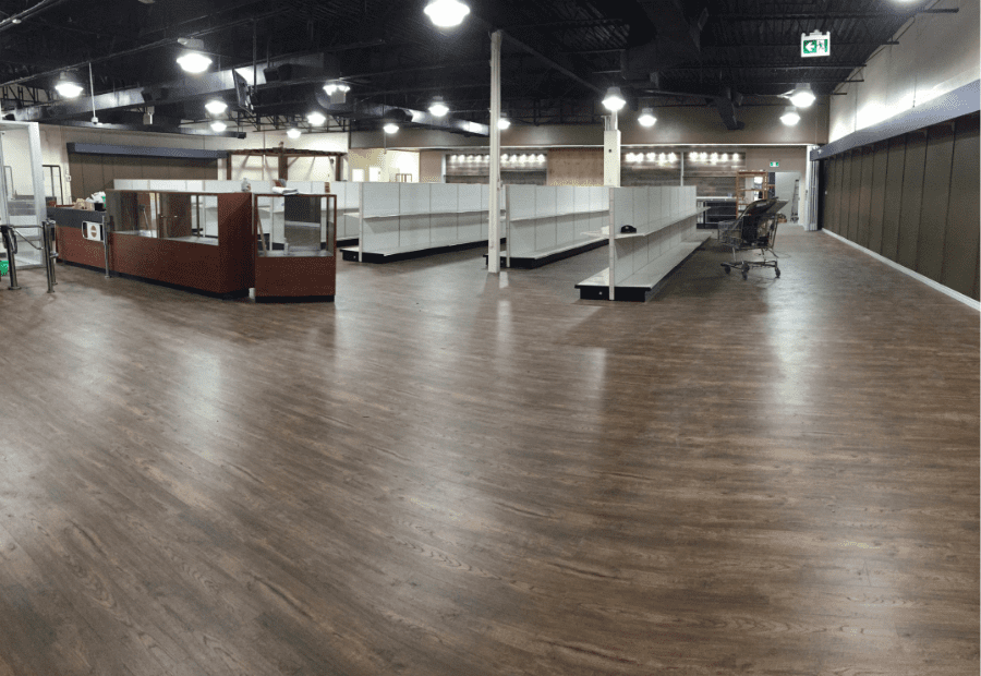 This outdoor equipment retail store renovation showcases a spacious open-concept layout with newly installed durable vinyl flooring, modern ceiling lighting, and custom display shelving. Reno Compass Inc. transformed the commercial space into a clean, functional, and customer-friendly retail environment, ideal for showcasing outdoor products while ensuring long-term durability and easy maintenance.
