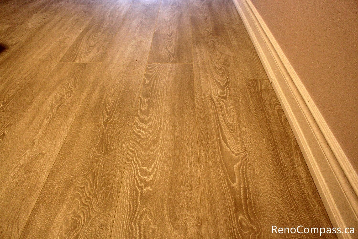 New oak-style wide plank flooring installed in a bedroom during an Oshawa home remodel. Durable, scratch-resistant flooring solutions by RenoCompass.ca designed to modernize living spaces throughout the Durham Region.