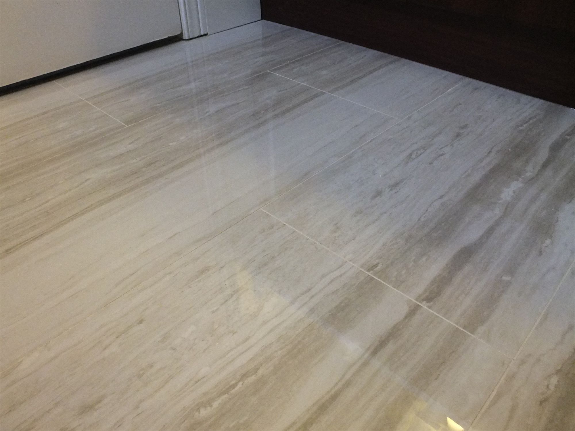 This image highlights the bathroom floor tile installation as part of a North York interior renovation. The large-format tiles are laid with precise alignment and clean grout lines, creating a smooth, durable surface that enhances both visual continuity and everyday functionality. The neutral stone texture complements the overall bathroom design while ensuring easy maintenance and long-term performance.