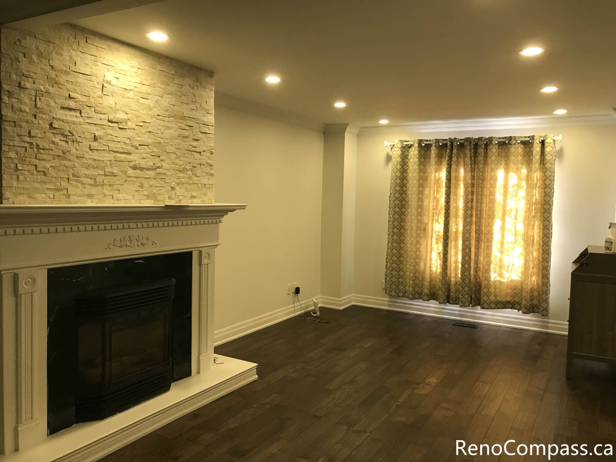 This Mississauga interior renovation highlights a bright bay window living space enhanced with custom curtain installation, detailed trim work, and rich hardwood flooring. The upgraded windows improve natural light control while adding warmth and elegance to the room. Completed by a trusted Toronto renovation company, Reno Compass Inc., this project showcases refined interior finishing and professional craftsmanship.
