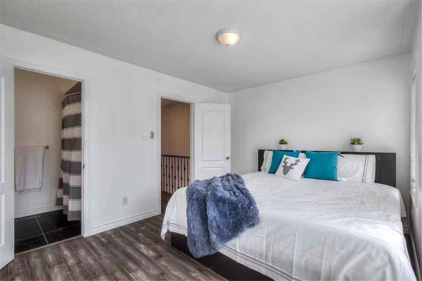 This Thornhill interior renovation features a bright and refreshed bedroom with new wood-style flooring, smooth white wall painting, and clean modern finishes. The upgraded space offers improved comfort, lighting, and functionality, creating a warm and inviting bedroom environment. Completed by a professional Toronto renovation team, this project highlights quality workmanship and contemporary interior design for modern family living.
