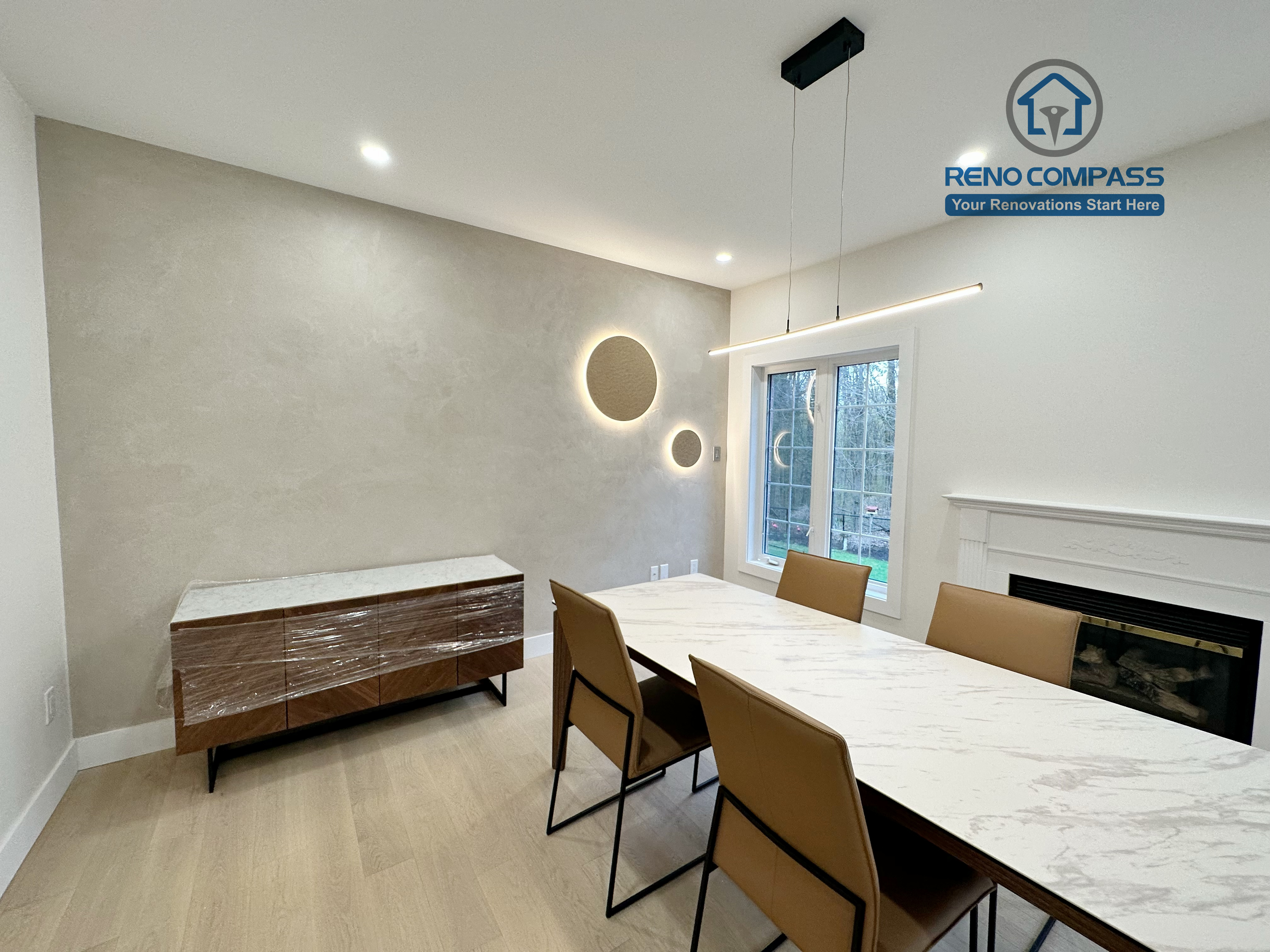 Modern dining area in a Richmond Hill home featuring light-tone hardwood flooring, a custom accent wall with integrated lighting, contemporary pendant fixtures, and a clean, elegant interior layout.
