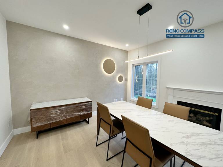Modern dining area in a Richmond Hill home featuring light-tone hardwood flooring, a custom accent wall with integrated lighting, contemporary pendant fixtures, and a clean, elegant interior layout.