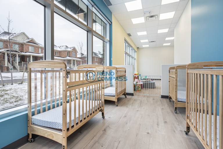 Renovated daycare hallway and common area in Richmond Hill with improved lighting, clear circulation, and durable materials to support high daily usage.