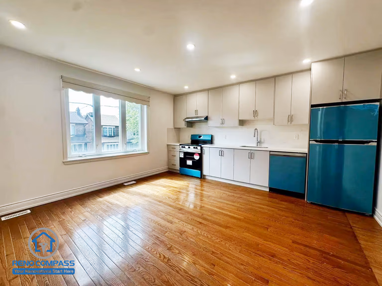 This second-floor rental unit features an open-concept kitchen and living area with ample natural light and hardwood flooring. Designed for a Toronto legal 3-unit conversion, the layout maximizes space efficiency and tenant comfort, making it ideal for long-term rental use.