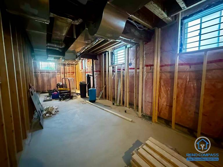 Before renovation image of a basement in Newmarket with exposed structure and insulation. Starting point of a full basement renovation project.