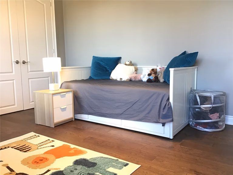 This Markham full home renovation features a cozy and functional kids’ bedroom with hardwood flooring, soft lighting, and a practical layout for everyday living. The space is designed to be comfortable and family-friendly, with room for rest, play, and storage. Completed by a trusted Toronto Renovation Company, this design supports both comfort and long-term usability.