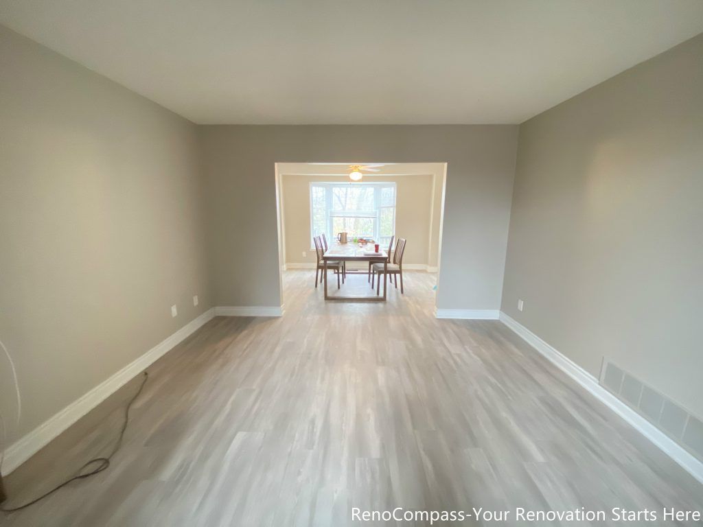This Mississauga interior renovation showcases an open living and dining area finished with light-toned flooring and neutral wall colors. The extended sightline connects the living space seamlessly to the dining area, enhancing openness and natural light flow. Clean lines and a balanced layout improve daily functionality, creating a bright, versatile interior suitable for family living, entertaining, and long-term comfort.