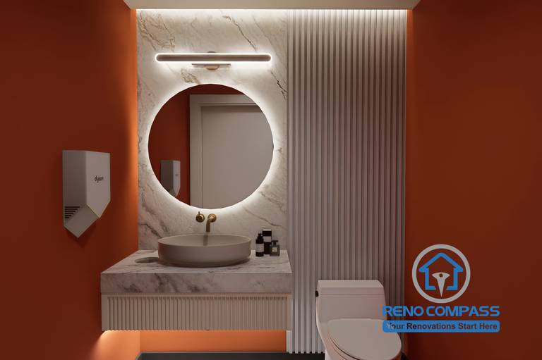 A premium washroom interior in a Markham medical aesthetic clinic renovation project, featuring Hermès orange walls, marble vanity, and soft backlit mirror to enhance cleanliness, comfort, and client experience.
