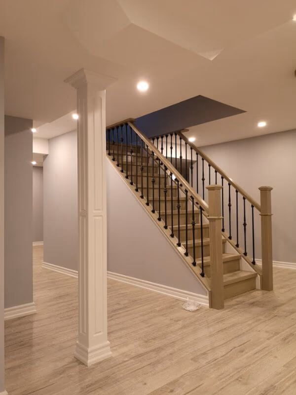 This finished basement renovation in Markham showcases a bright open-concept layout with new flooring, upgraded staircase, modern columns, and recessed lighting. Completed by a trusted Toronto renovation company, the project transforms the basement into a spacious and comfortable living area, enhancing both property value and everyday functionality.