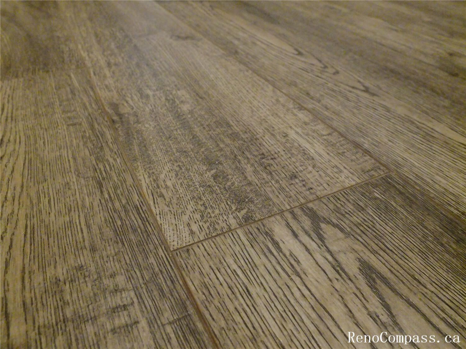 Close-up view of newly installed waterproof vinyl plank flooring in this Ajax basement renovation. The wood-grain texture and durable surface provide a modern look while ensuring moisture resistance and long-term performance—an ideal flooring solution for basement living spaces. Installed by a professional Toronto Renovation Company, the flooring enhances both the durability and visual appeal of the renovated basement area.