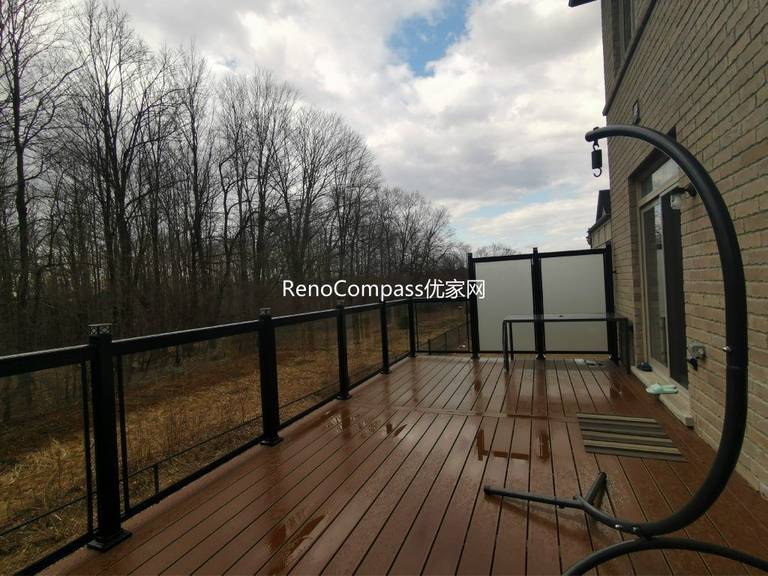 Professional deck construction project in Aurora featuring durable composite wood decking, modern black aluminum and glass railings, and a spacious outdoor layout. Designed for long-term durability and low maintenance, this backyard deck enhances outdoor comfort, safety, and property value.