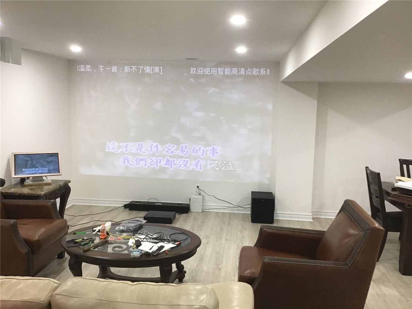 This Aurora basement renovation highlights a cozy home theater setup with a projector screen, comfortable seating, and a relaxed lounge atmosphere. The space is designed for entertainment and everyday living, featuring warm lighting, soft-toned flooring, and an inviting open layout.