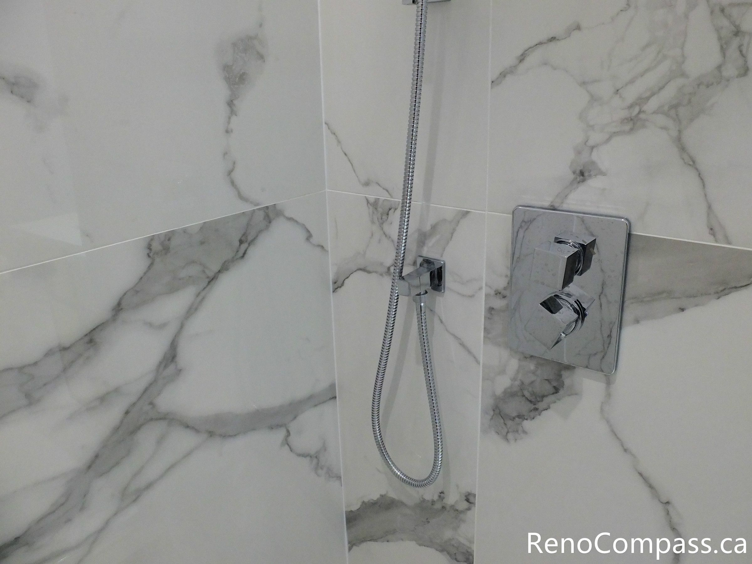 This Richmond Hill bathroom renovation highlights precision installation of a modern shower control valve with marble-look porcelain wall tiles. Completed by a professional Toronto renovation company, the clean tile alignment and high-quality plumbing fixtures create a sleek, durable, and contemporary shower space designed for long-term performance and style.