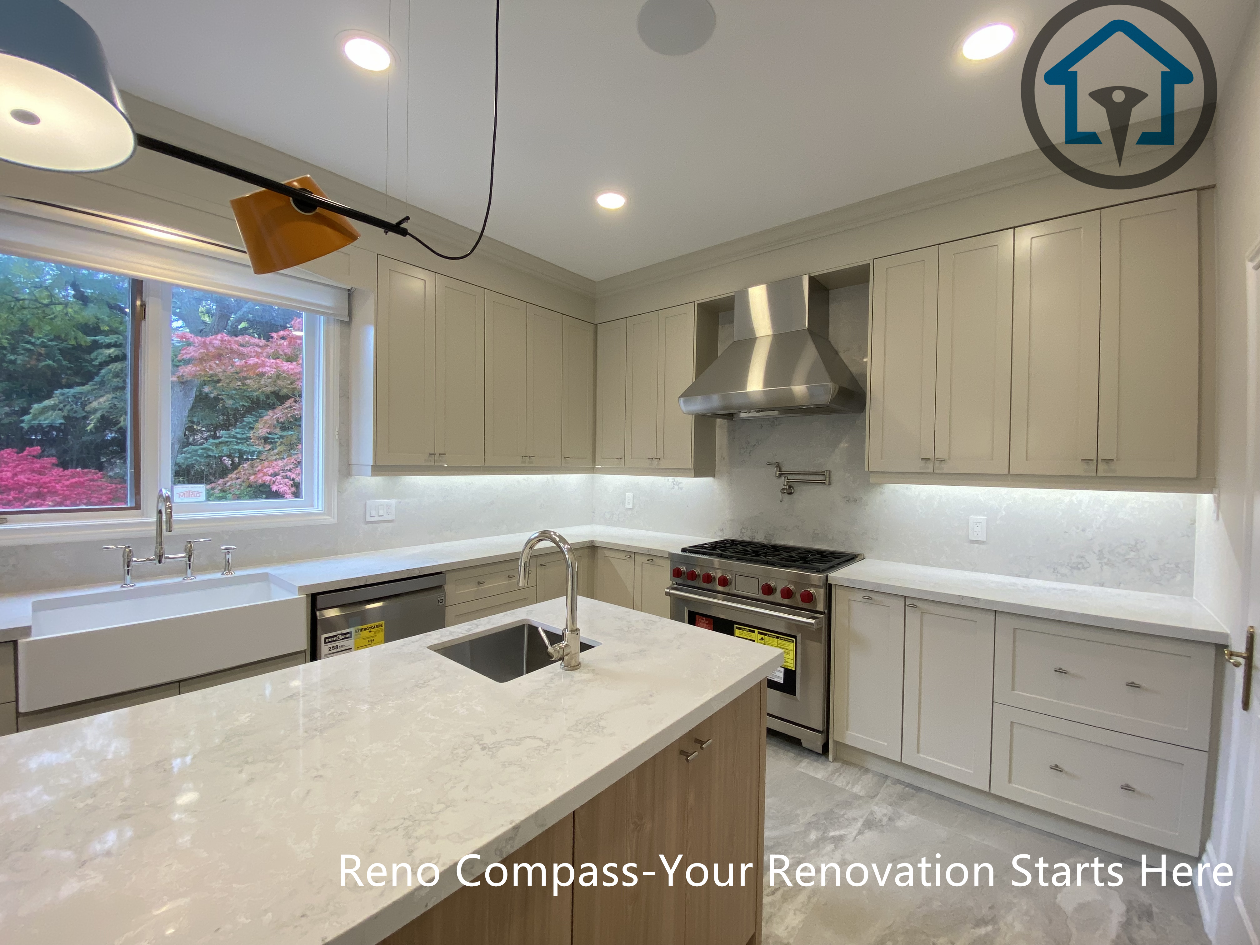 This kitchen renovation features a central island with integrated sink, custom cabinetry, and a gas range with stainless steel hood, creating an efficient and well-organized workspace. Completed as part of a Thornhill home renovation by Reno Compass.