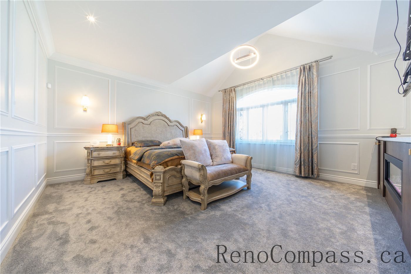 This Richmond Hill entire house interior renovation features a spacious master bedroom suite with a cozy sitting area, built-in fireplace feature, and elegant wall paneling. Soft carpeting, large windows, and warm lighting create a comfortable and luxurious retreat designed for relaxation. Completed by a trusted Toronto renovation company, this master bedroom renovation combines modern comfort, refined finishes, and functional layout to elevate everyday living.