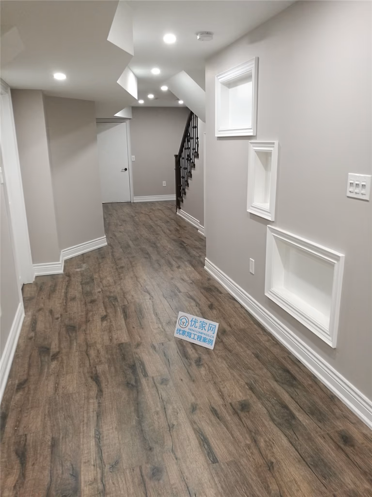 Finished basement renovation in Richmond Hill featuring durable wood-look flooring, recessed pot lighting, smooth drywall finishes, and a clean modern layout. This basement remodel improves lighting, flow, and overall usability, completed by a trusted Toronto renovation company.