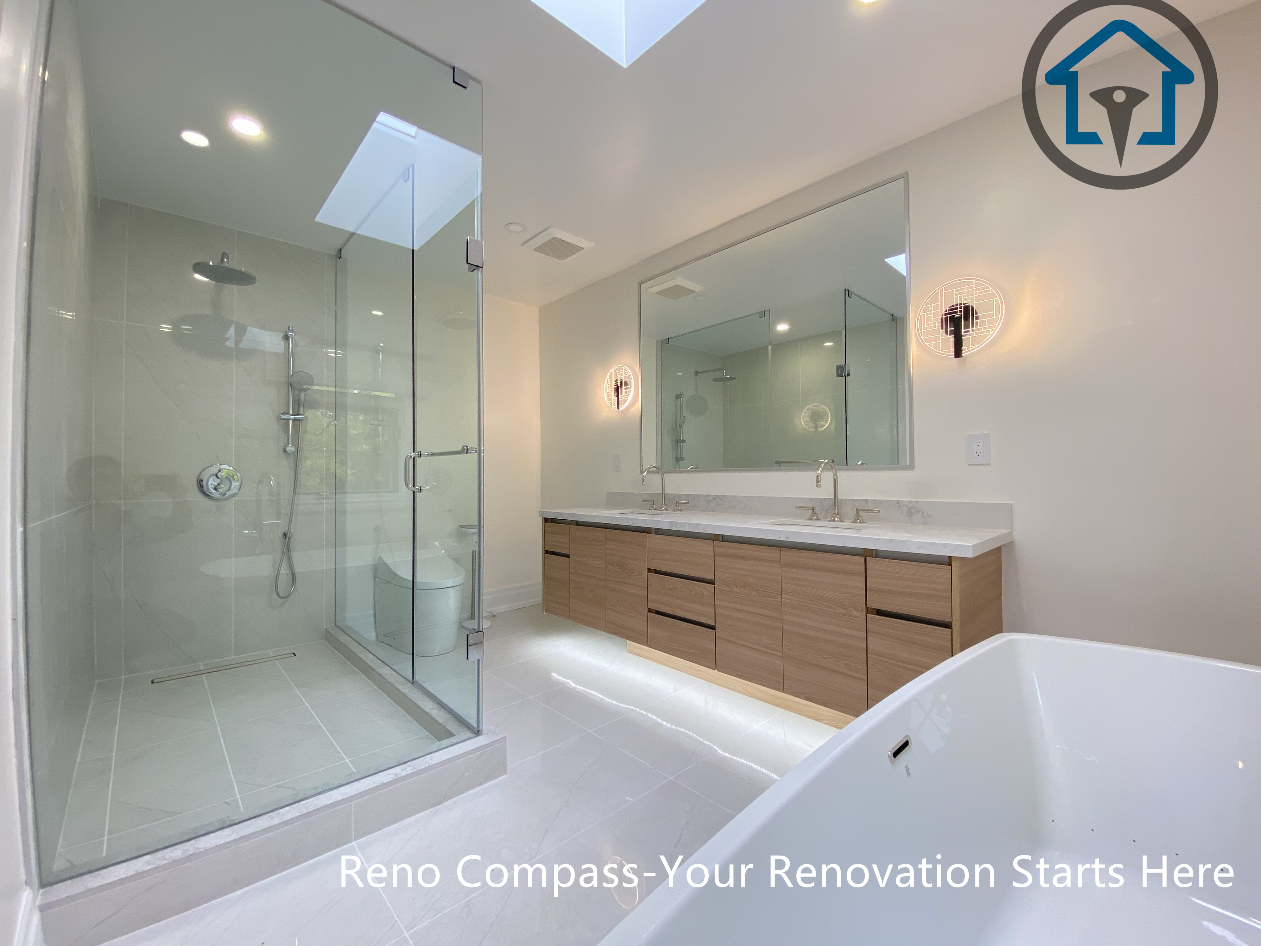A modern bathroom renovation featuring a freestanding bathtub, glass-enclosed shower, and custom wood vanity with integrated lighting. Designed for a clean, spacious, and functional layout in a Thornhill home by Reno Compass.