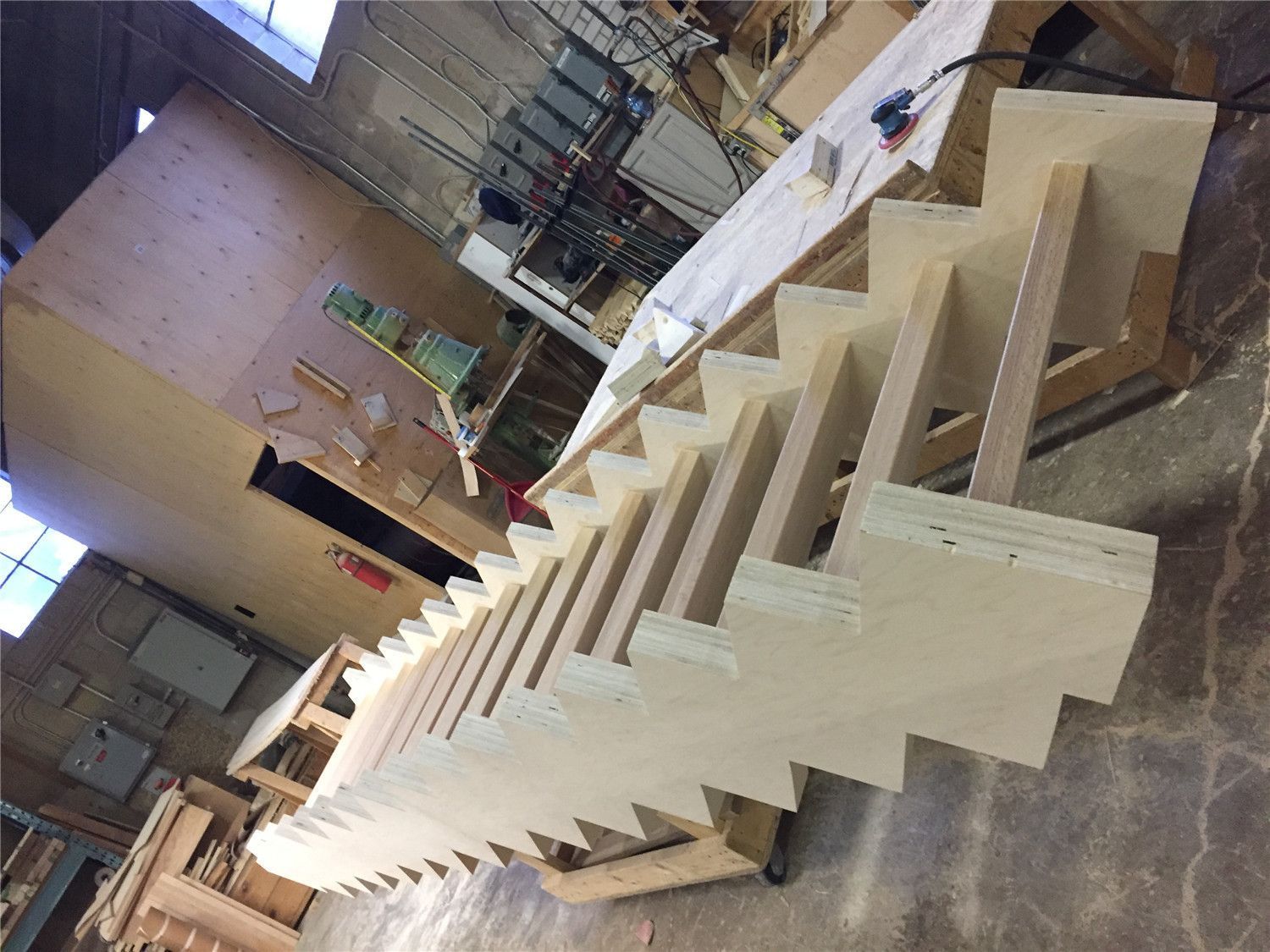 This image shows a custom hardwood staircase frame being built for a Toronto stair renovation project. The staircase structure is carefully fabricated with precise step spacing and strong side support to ensure stability, durability, and a clean final finish. This stage highlights the detailed carpentry work behind a high-quality custom stair build. As a reliable Toronto Renovation Company, Reno Compass Inc. provides expert staircase renovation and custom wood construction services for homes across Toronto and the GTA.