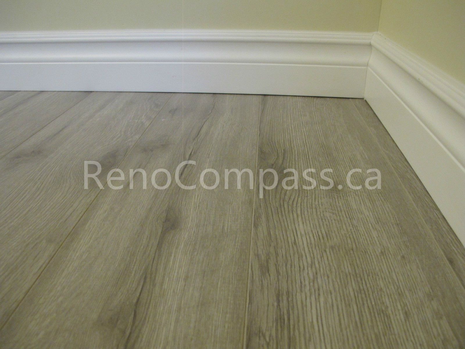 New waterproof vinyl flooring installed in this Markham basement renovation project, featuring durable wood-look planks and clean modern baseboards. Completed by Reno Compass, this basement upgrade enhances comfort, moisture resistance, and contemporary interior style for a functional finished living space.