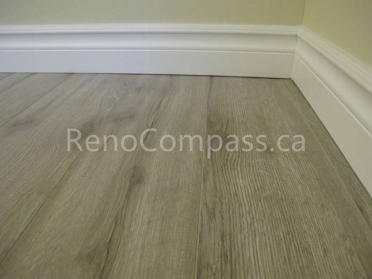 New waterproof vinyl flooring installed in this Markham basement renovation project, featuring durable wood-look planks and clean modern baseboards. Completed by Reno Compass, this basement upgrade enhances comfort, moisture resistance, and contemporary interior style for a functional finished living space.