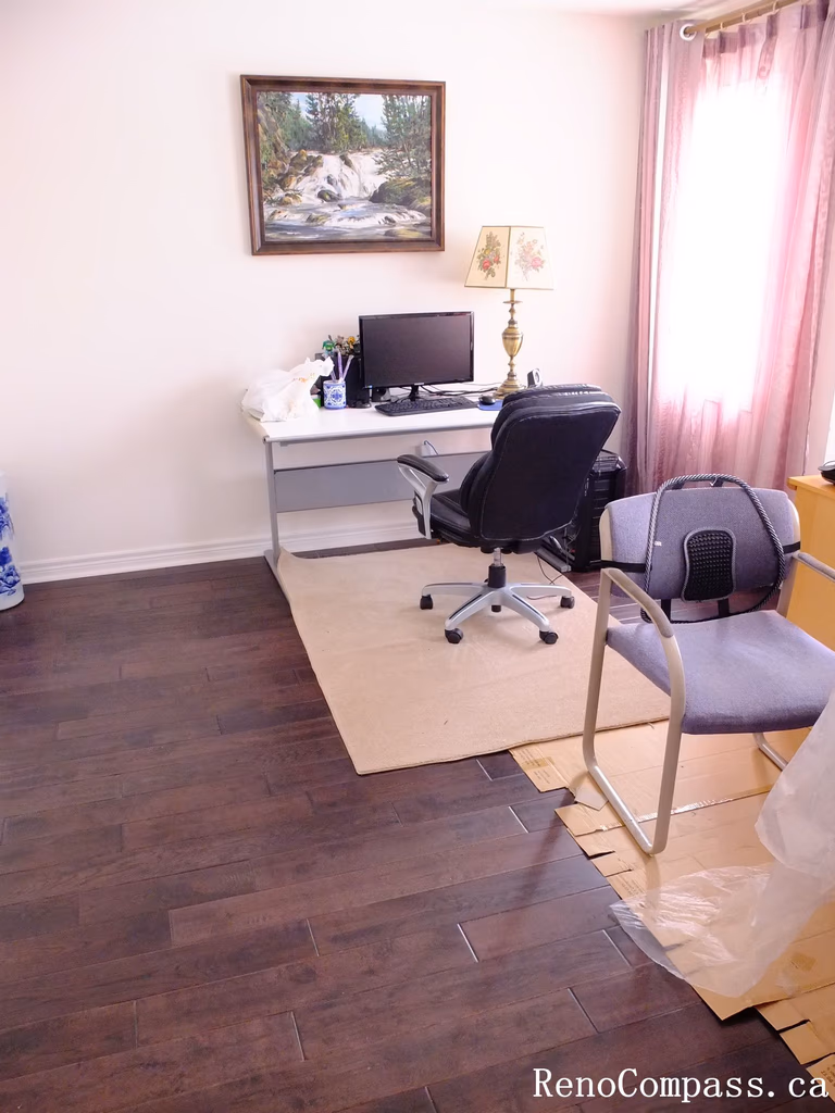 Toronto home hardwood flooring installation featuring deep-toned wood floors throughout the hallway and upper level. This professional flooring renovation enhances brightness, durability, and visual continuity, completed by Reno Compass for a clean and modern interior upgrade.