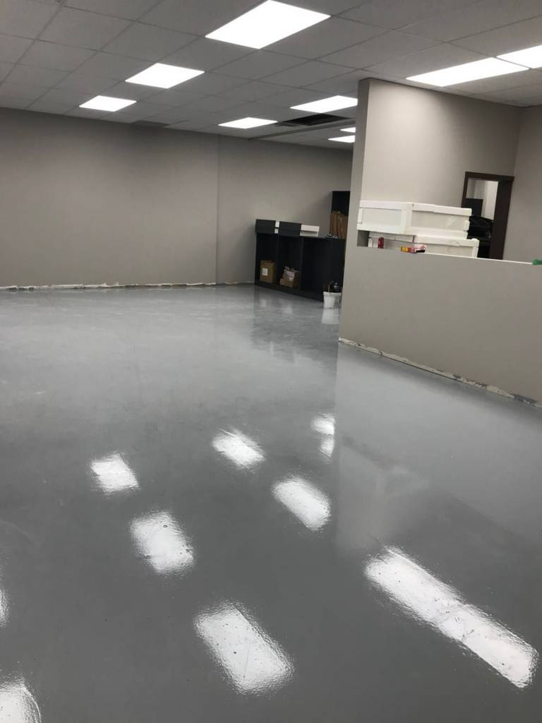 This Toronto commercial renovation project showcases a newly upgraded industrial epoxy flooring system designed for durability, low maintenance, and a clean professional appearance. The seamless grey epoxy finish enhances brightness by reflecting overhead lighting while providing a smooth, easy-to-maintain surface ideal for office, retail, or light industrial use. Completed with precision and efficiency, this commercial space transformation demonstrates high-quality workmanship and modern interior upgrading standards suitable for Toronto business environments.