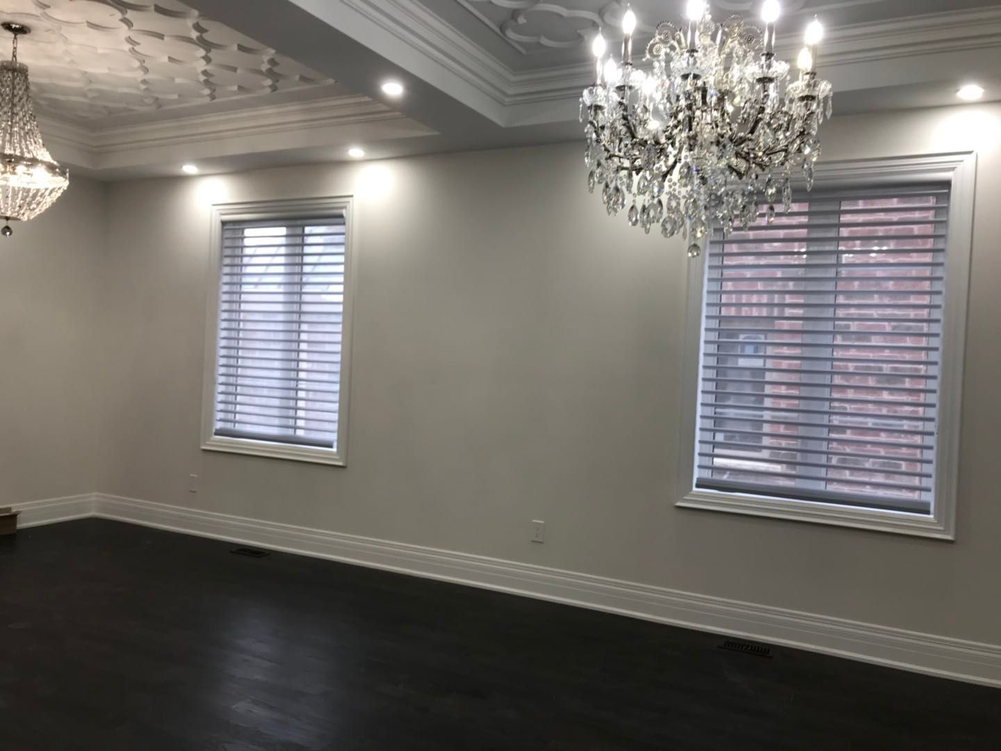 Custom zebra blinds installation in Toronto dining room by professional Toronto renovation company Reno Compass Inc. Featuring dual-layer light filtering shades, clean white window trim, modern chandelier lighting, and elegant wall panel detailing. This window treatment upgrade enhances privacy, natural light control, and interior aesthetics with a sleek and contemporary finish.