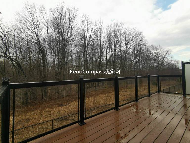 Professional deck construction project in Aurora featuring durable composite wood decking, modern black aluminum and glass railings, and a spacious outdoor layout. Designed for long-term durability and low maintenance, this backyard deck enhances outdoor comfort, safety, and property value.