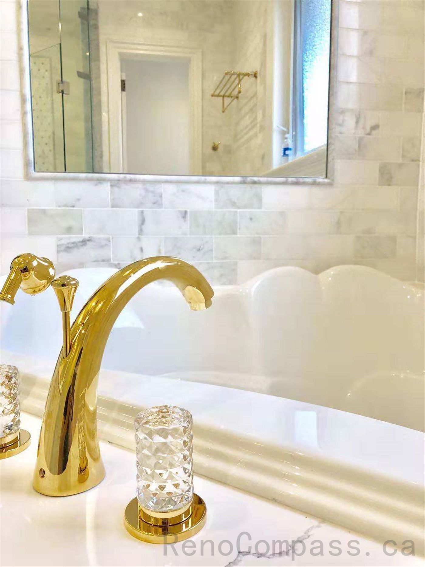 This North York bathroom renovation highlights refined material details, featuring a gold faucet set into a quartz vanity countertop with classic white subway tile backsplash. The close-up view emphasizes craftsmanship, finish quality, and cohesive material selection within a modern bathroom design.