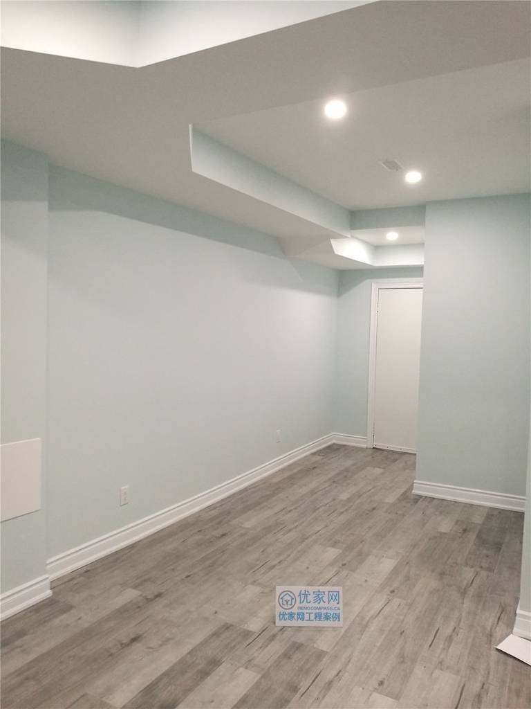 This newly finished basement room in Vaughan features durable wood-look flooring, smooth neutral walls, and recessed ceiling lighting to create a clean and contemporary space. Completed by a professional Toronto renovation company, the basement upgrade enhances functionality and comfort, making it ideal for a guest room, home office, or additional living area.