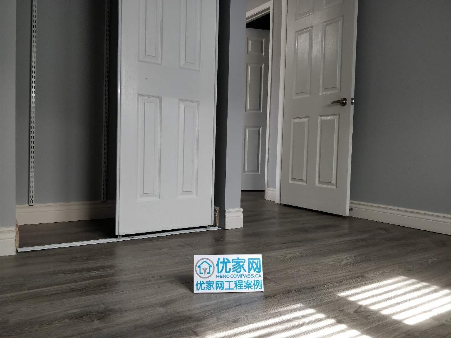 This bedroom renovation in Ajax features upgraded grey-tone flooring and a functional closet installation with sliding doors. The space is designed for both comfort and efficiency, with clean wall finishes and improved natural lighting. As part of a full house renovation project, the flooring and storage upgrades enhance everyday usability while maintaining a modern and cohesive interior style.