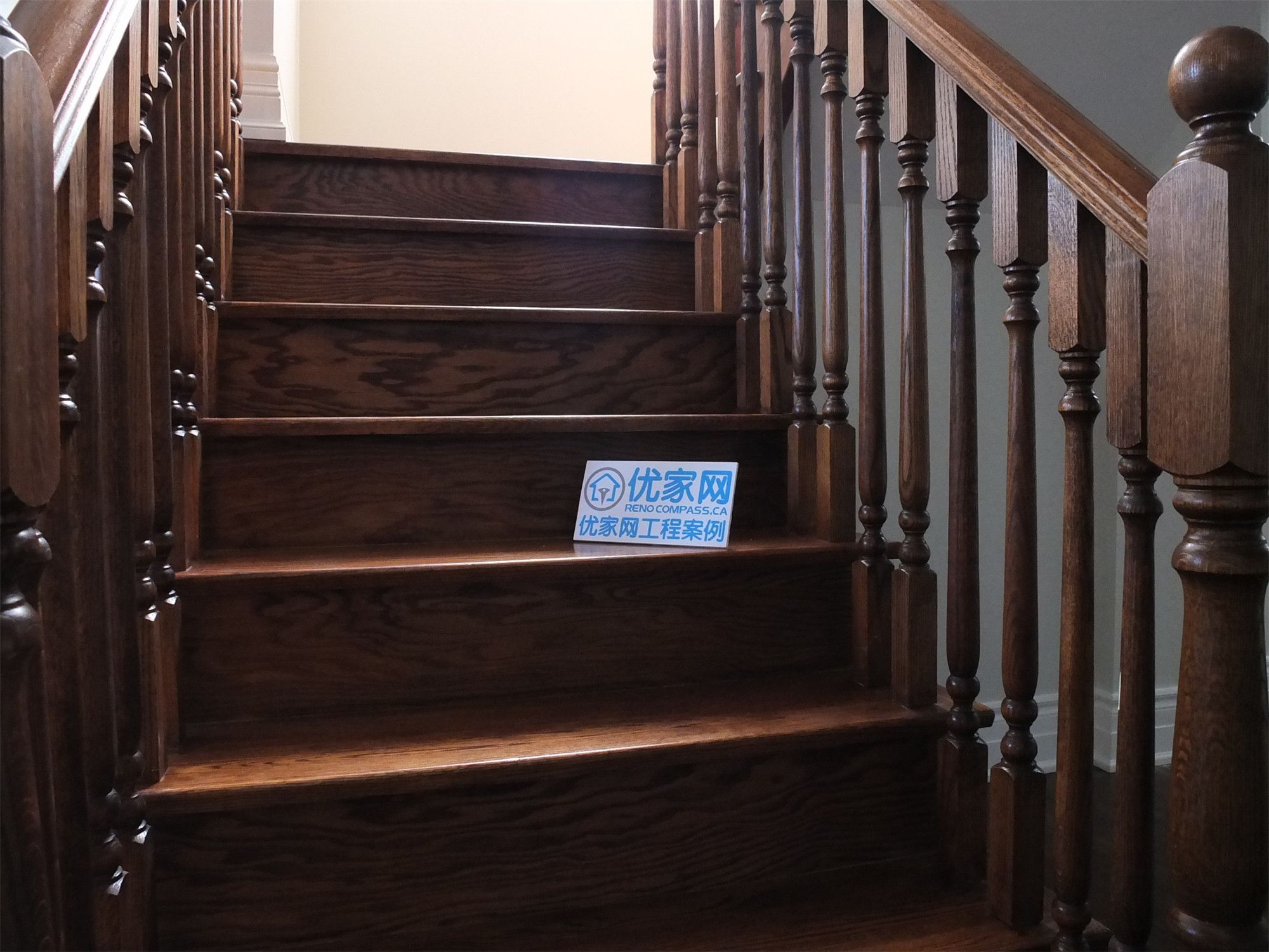 This Richmond Hill basement renovation features a beautifully crafted hardwood staircase with custom wood railings and detailed baluster design. The rich wood tones and precise finishing highlight high-quality craftsmanship, adding warmth and elegance to the transition between floors.