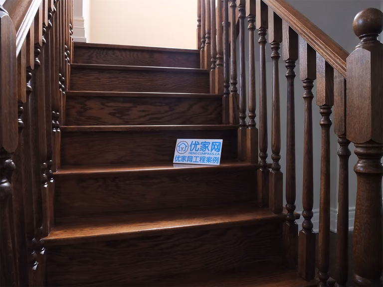 This Richmond Hill basement renovation features a beautifully crafted hardwood staircase with custom wood railings and detailed baluster design. The rich wood tones and precise finishing highlight high-quality craftsmanship, adding warmth and elegance to the transition between floors.