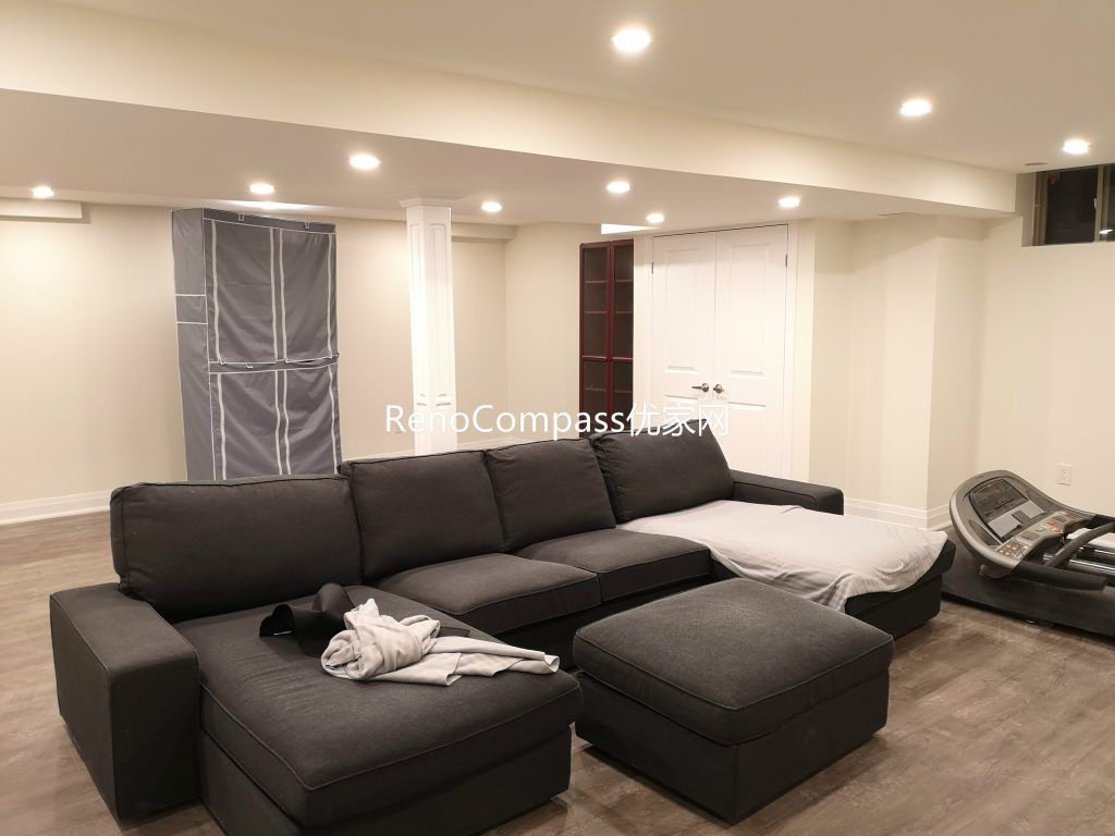 Spacious Richmond Hill basement entertainment area featuring open layout, sectional sofa lounge, upgraded flooring, and modern pot light ceiling design. Completed by Reno Compass Inc., this basement renovation creates a comfortable multi-purpose family and recreation space.