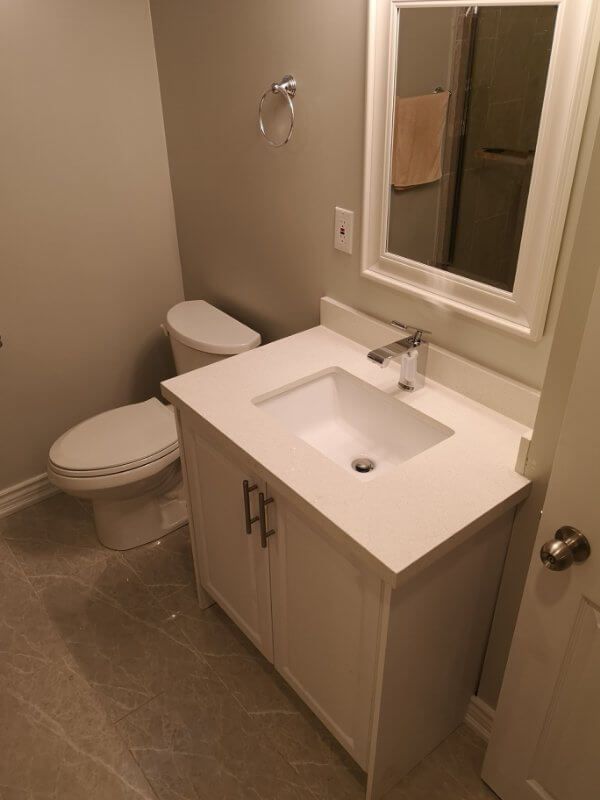 This Markham basement bathroom renovation features a modern vanity installation, upgraded tile flooring, and clean neutral finishes for a fresh and functional space. Completed by a trusted Toronto renovation company, the project improves basement comfort, storage, and overall home value while creating a bright and easy-to-maintain bathroom design.
