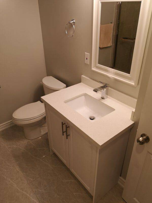 This Markham basement bathroom renovation features a modern vanity installation, upgraded tile flooring, and clean neutral finishes for a fresh and functional space. Completed by a trusted Toronto renovation company, the project improves basement comfort, storage, and overall home value while creating a bright and easy-to-maintain bathroom design.