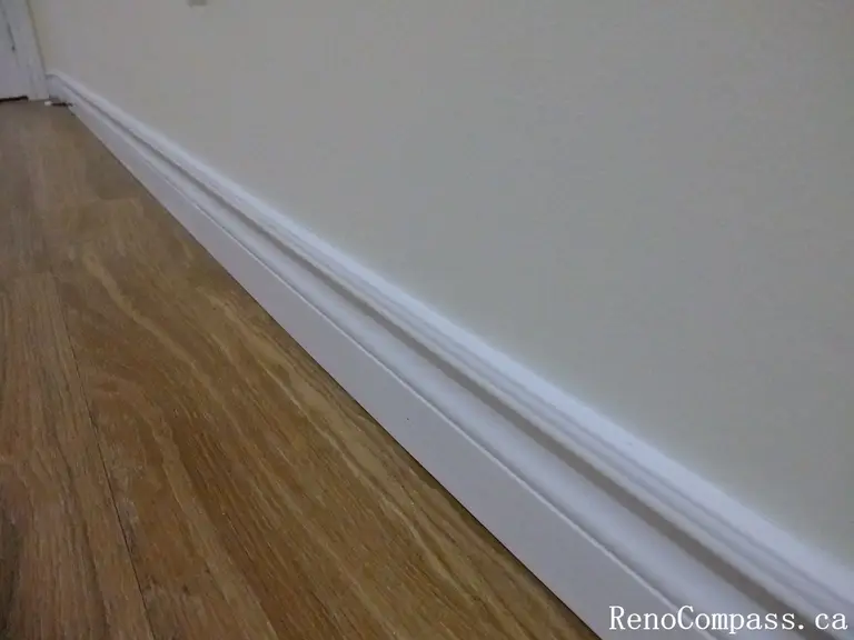 Close-up detail of newly installed white baseboards and durable wood-look basement flooring in this Richmond Hill basement renovation. The clean trim lines and seamless corner finishing highlight the craftsmanship and attention to detail. As part of a professionally completed project by a leading Toronto Renovation Company, this finishing work enhances both durability and overall visual appeal.

Send the next image and I’ll continue keeping the SEO format consistent for the full project gallery.