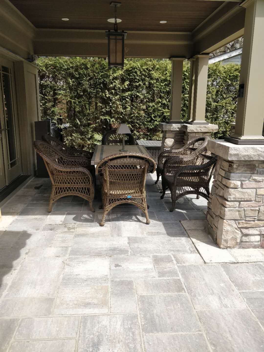 Oakville backyard covered patio featuring stone columns, architectural pillars, and a spacious seating area. Designed for comfort, shade, and elegant outdoor living.