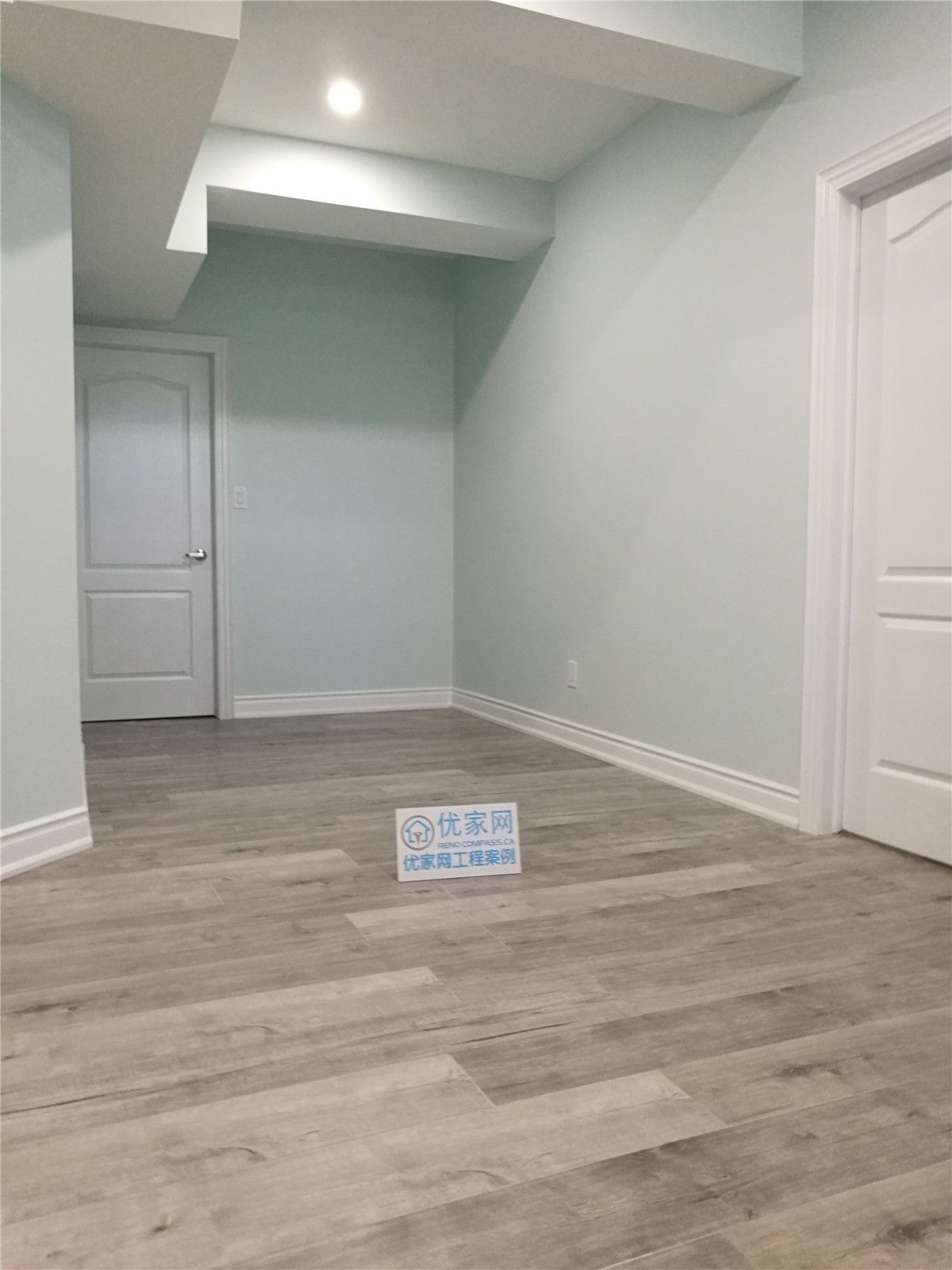 This Vaughan basement renovation features durable vinyl flooring, soft neutral wall tones, and modern recessed ceiling lighting to create a bright and functional living space. Completed by a trusted Toronto renovation company, the upgraded basement offers improved layout, comfort, and a clean contemporary finish ideal for family use or rental potential.