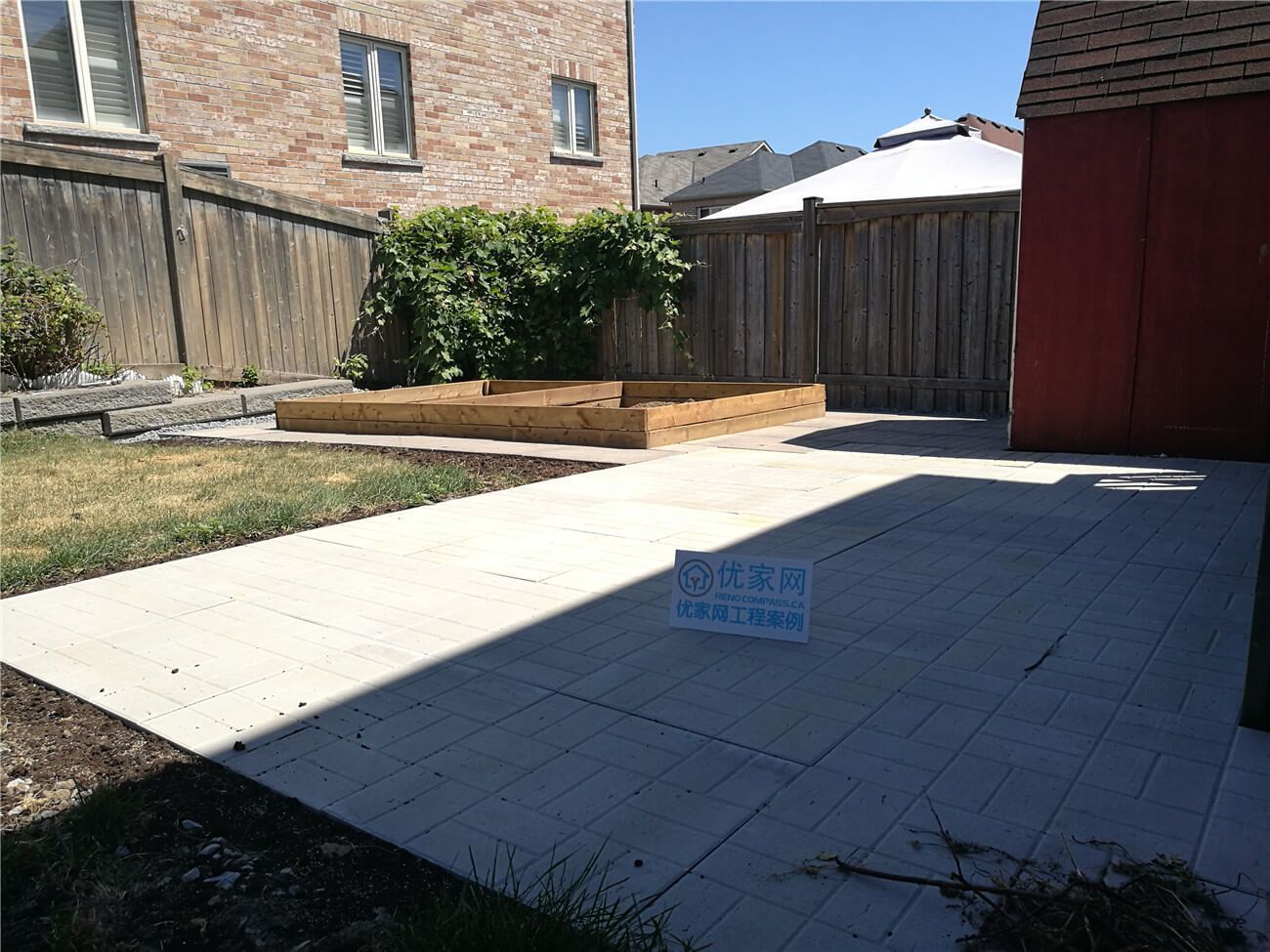 This Vaughan landscaping renovation project showcases a newly installed backyard patio with large-format concrete slabs, creating a clean and low-maintenance outdoor living space. The spacious hardscape area enhances functionality for entertaining and everyday use, while the custom-built wooden raised garden bed adds warmth and structure to the yard layout. Completed by Reno Compass Inc., this project combines durable materials, precise installation, and a balanced outdoor design suited for modern Vaughan homes.