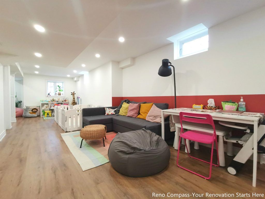 This image features a renovated basement family room in Vaughan, designed as a flexible living space suitable for relaxation, play, and everyday family activities. The layout combines comfortable seating, soft lighting, and durable wood flooring to create a welcoming and practical environment. Recessed ceiling lights and a small window provide balanced illumination, while the open arrangement allows the space to adapt to different uses such as lounging, children’s activities, or casual gatherings. This basement renovation demonstrates the thoughtful space planning and construction quality delivered by a professional Toronto renovation company focused on functional residential interiors.
