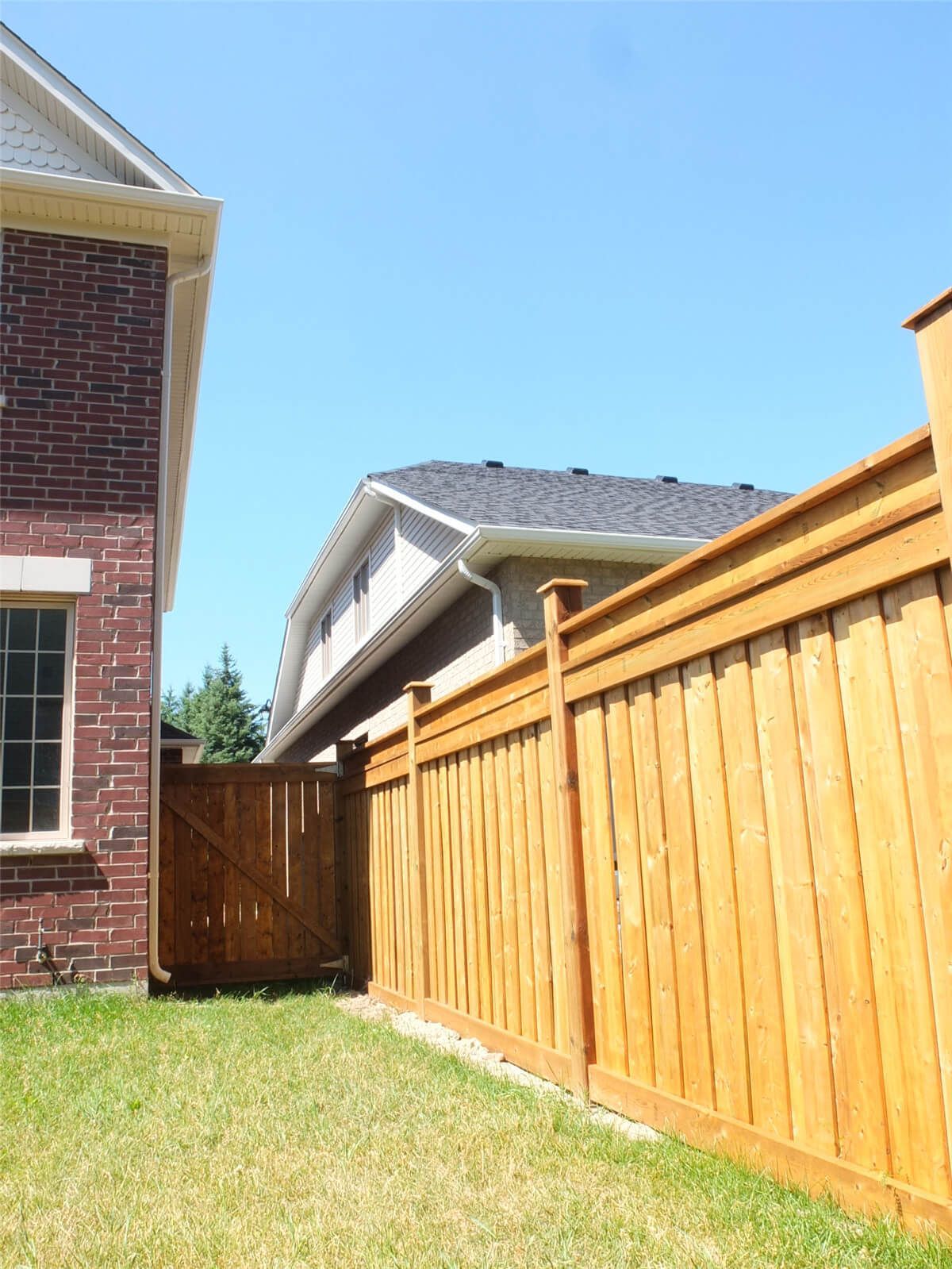 Side yard wood fence replacement with custom-built privacy gate for a detached home in Aurora. This project features pressure-treated lumber panels, reinforced fence posts, and a matching wooden gate for secure backyard access. Installed by a trusted Toronto Renovation Company specializing in residential exterior upgrades.