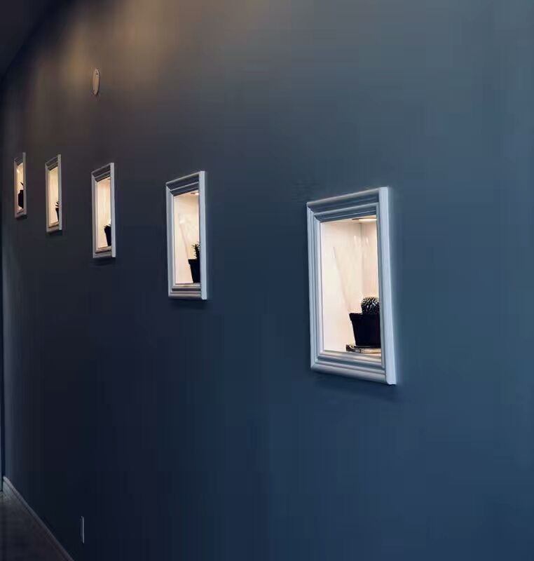 A stylish interior wall feature installed in a North York commercial renovation project. The dark accent wall is complemented by evenly spaced decorative framed display niches, creating a modern and artistic atmosphere for a restaurant or entertainment venue interior.