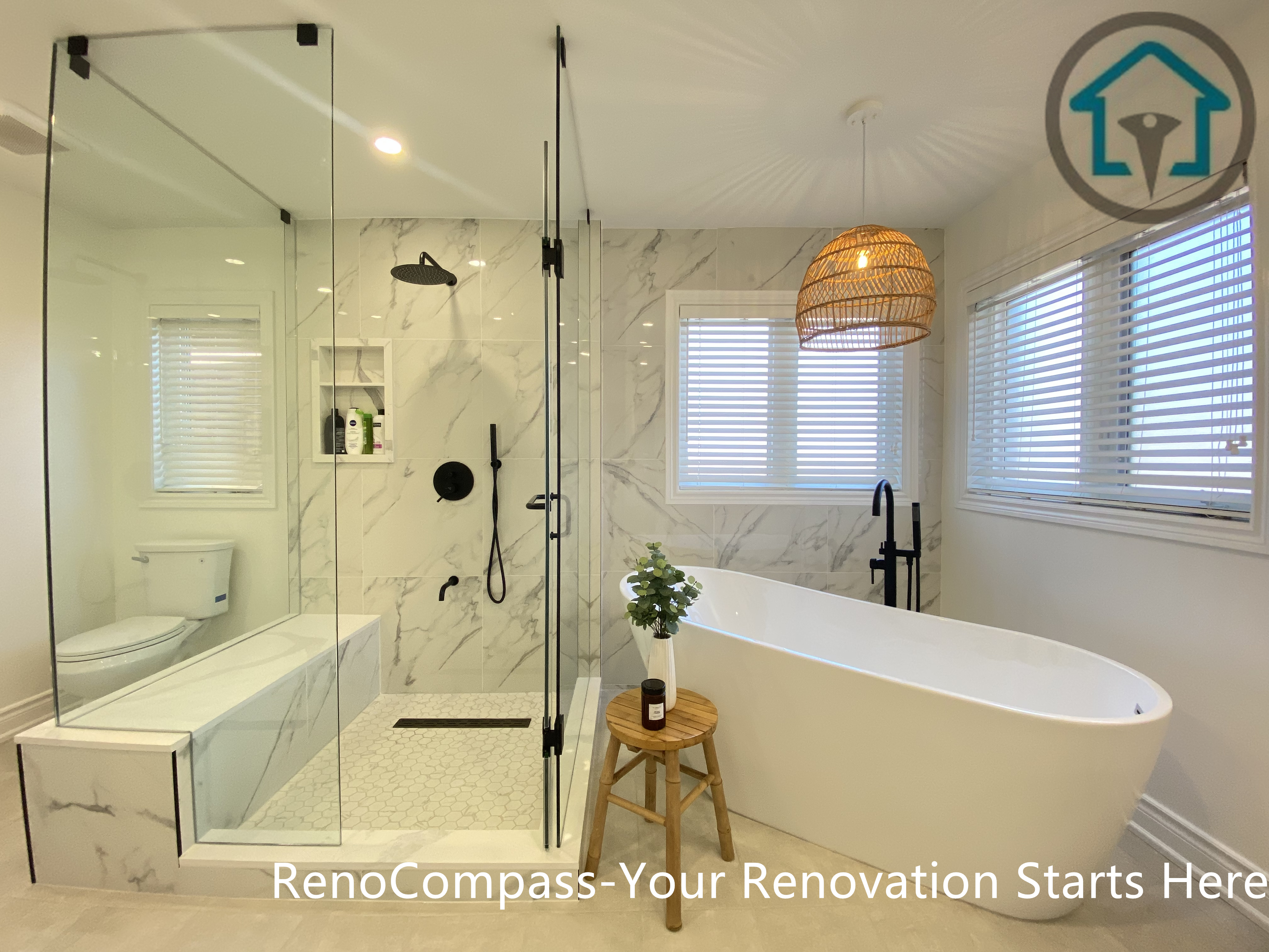 Modern Oakville bathroom renovation featuring a full glass walk-in shower, marble-look tile walls, matte black fixtures, and a freestanding bathtub. This bathroom remodel emphasizes clean lines, bright natural light, and a spa-inspired layout designed for both functionality and everyday comfort by a Toronto renovation company.