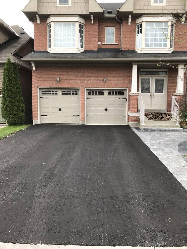 This Markham landscaping renovation showcases a newly installed asphalt driveway designed to provide a smooth, durable surface and improved curb appeal. The fresh paving creates a clean and functional entrance to the home while ensuring long-term performance for daily vehicle use. Completed by a professional Toronto Renovation Company, this exterior upgrade enhances both practicality and the overall appearance of the property.