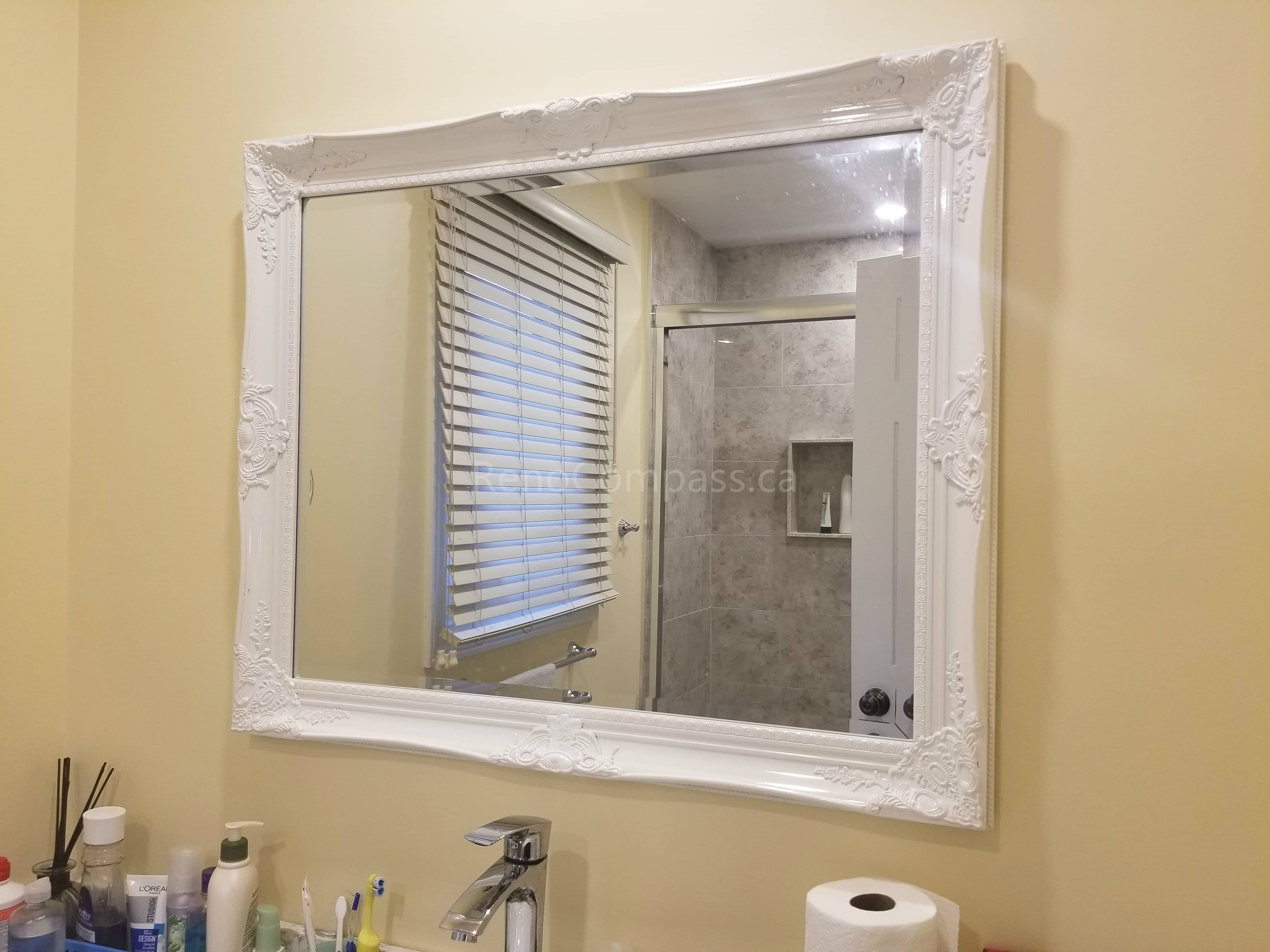 This Markham bathroom renovation project features a newly upgraded shower area with modern tiles, a refreshed vanity space, and a decorative framed mirror that enhances the overall aesthetic. The combination of new flooring, clean finishes, and functional layout creates a bright, comfortable, and stylish bathroom space designed for everyday use and long-term durability.