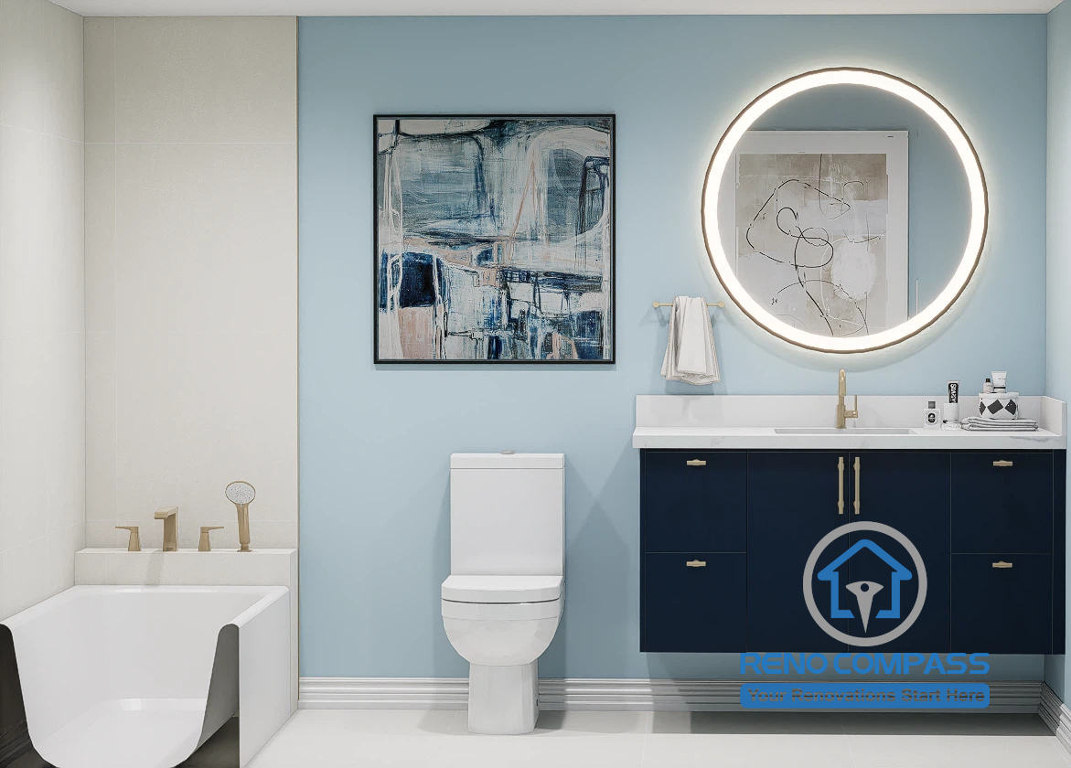 Professional bathroom renovation featuring a built-in bathtub, custom navy vanity, quartz countertop, round LED mirror, brushed gold faucet, and contemporary design. Expertly renovated by Reno Compass for homeowners across the Greater Toronto Area.